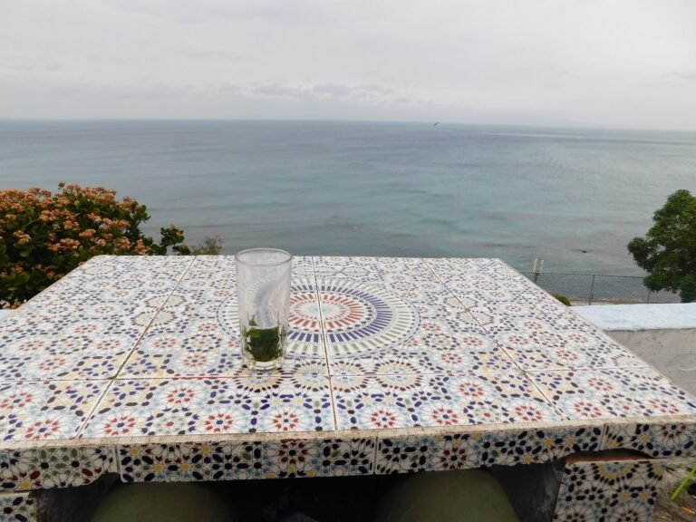 Mint tea on a mosaic table at Café Hafa, facing the Strait